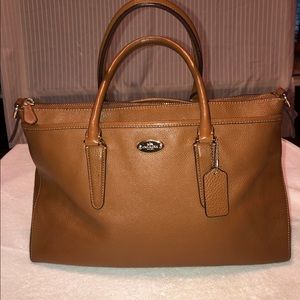 Tan leather satchel Coach bag.